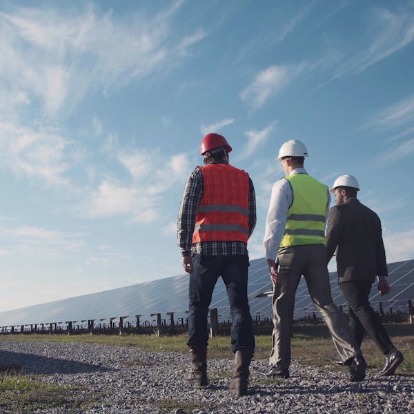 men in solar panel field