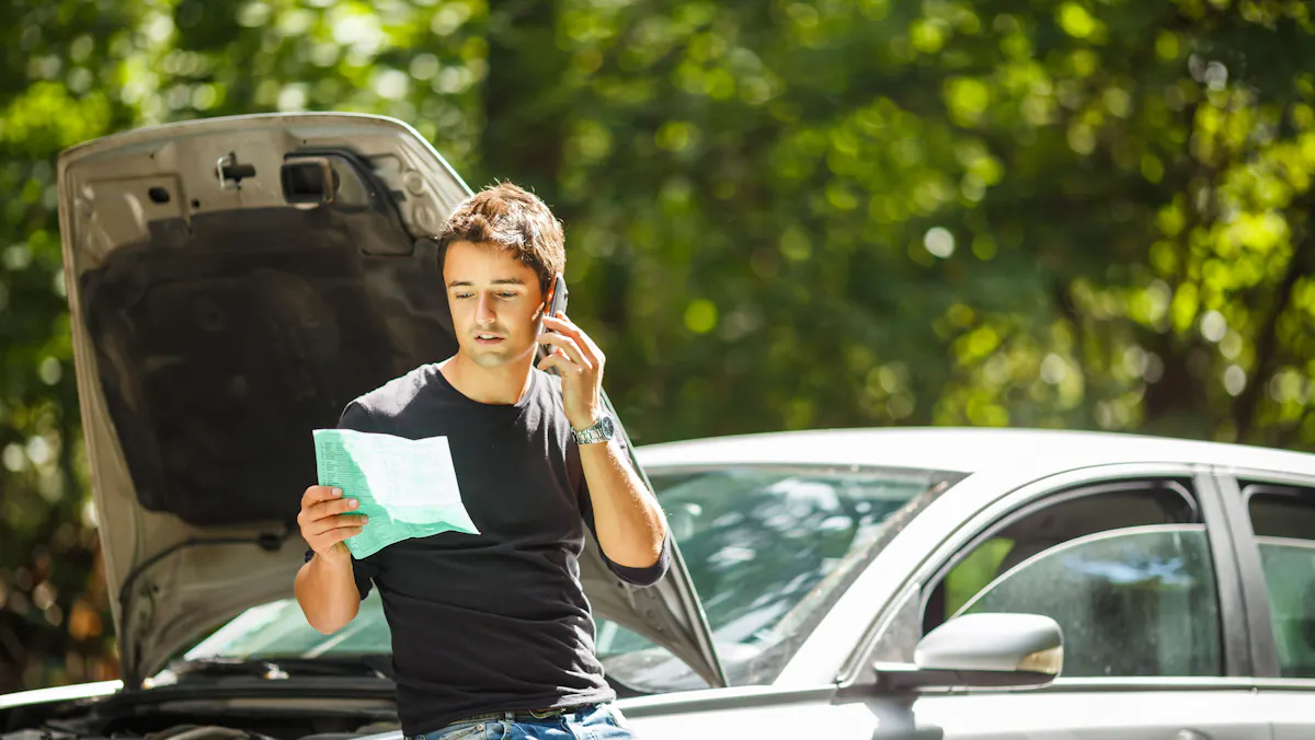 man with broken down car
