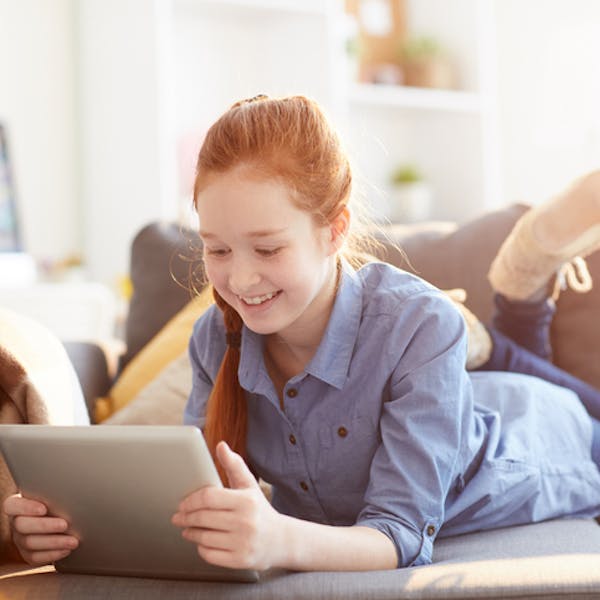 Teen on the couch with her tablet