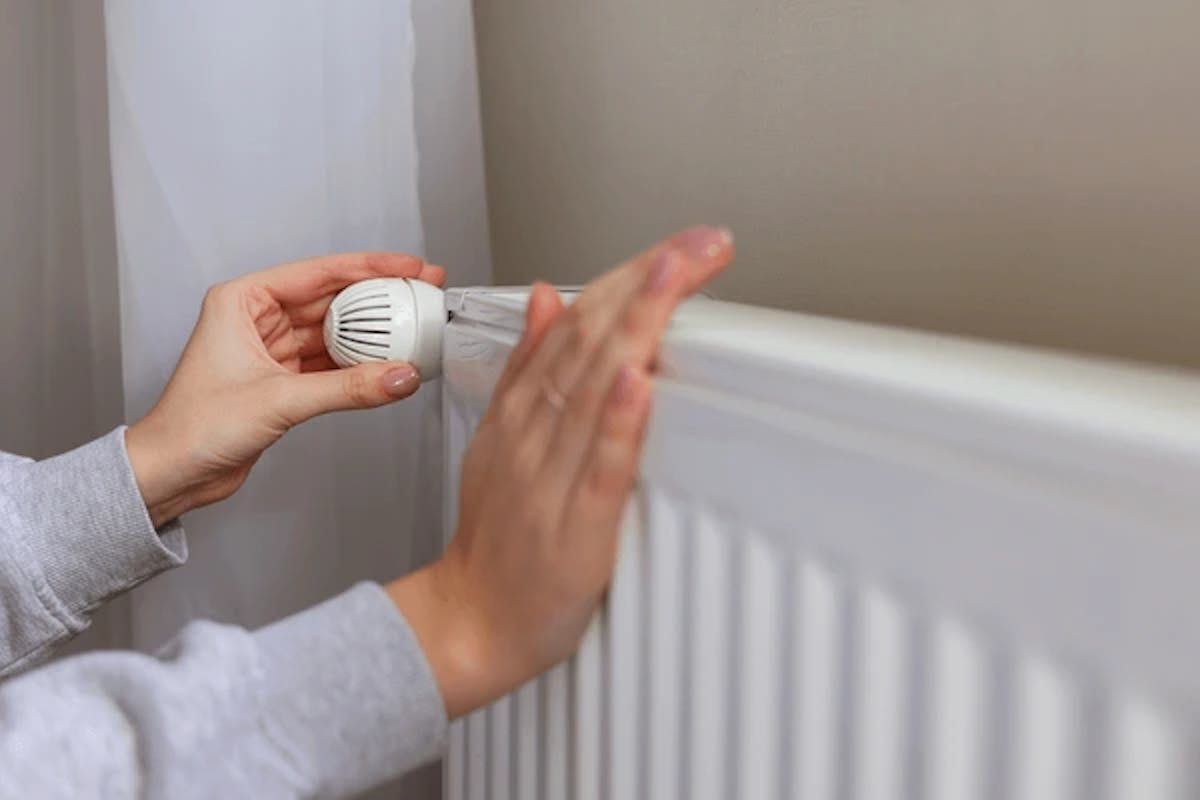 Girl Checking Radiator Heating For Repairs
