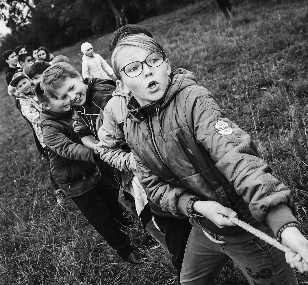 A group of children pull arope during a game of tug of war