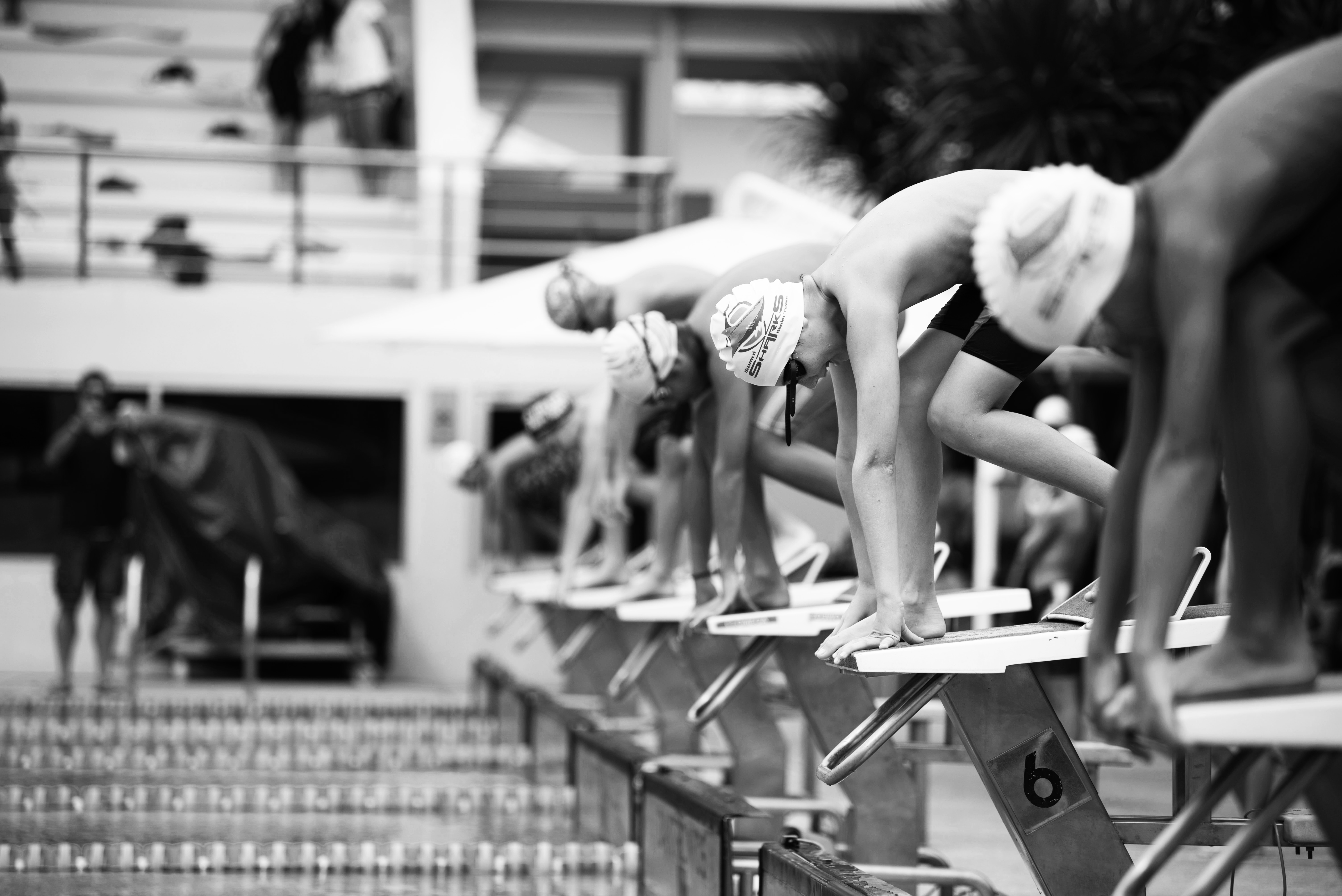 A heat of youth swimmers prepare for a race in a pool
