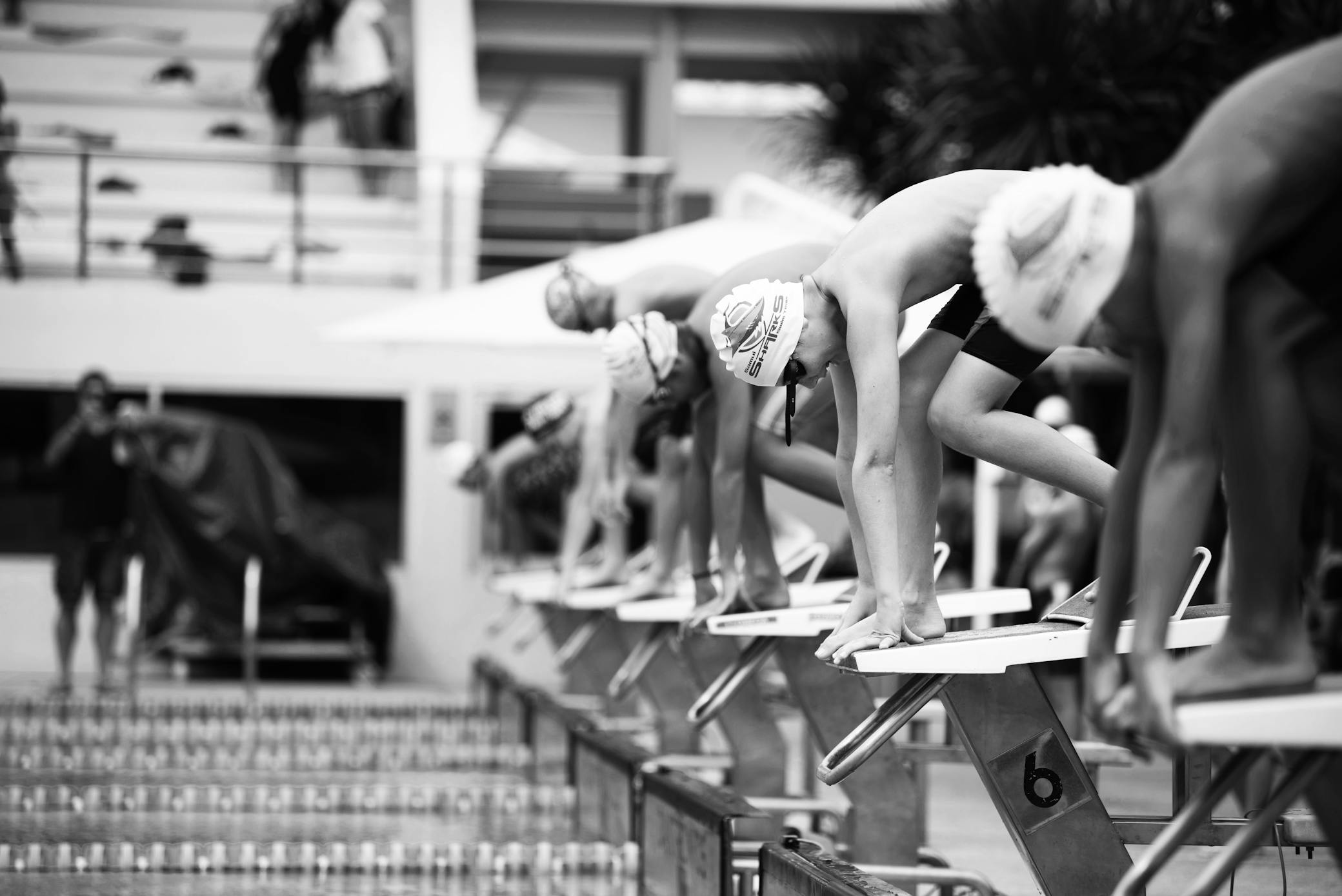 A heat of youth swimmers prepare for a race in a pool