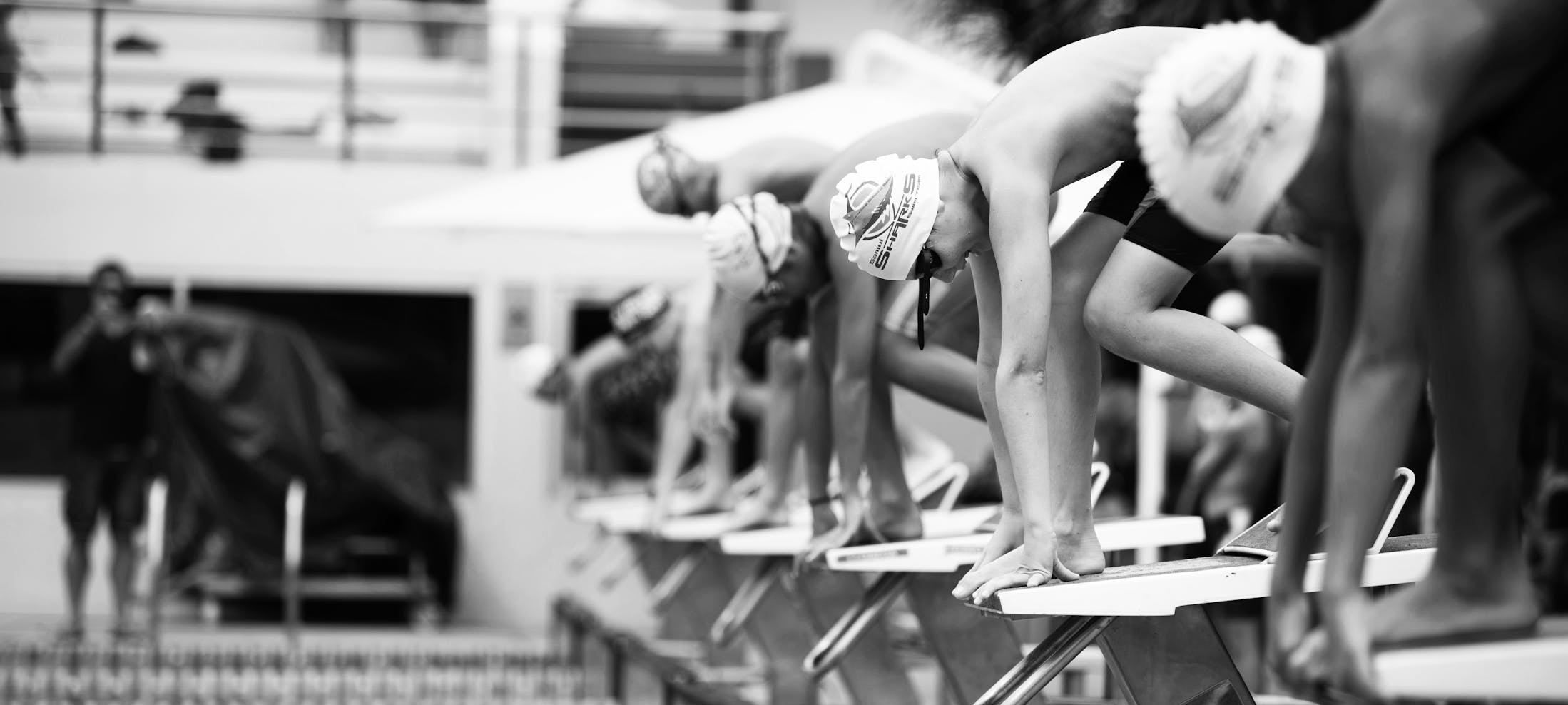 A heat of youth swimmers prepare for a race in a pool
