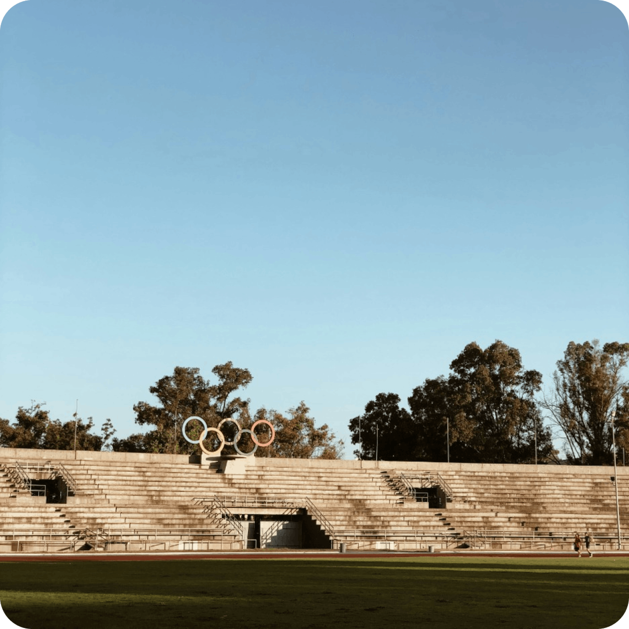 Outdoor sports field with the Olympic rings at community sports facility under clear blue sky
