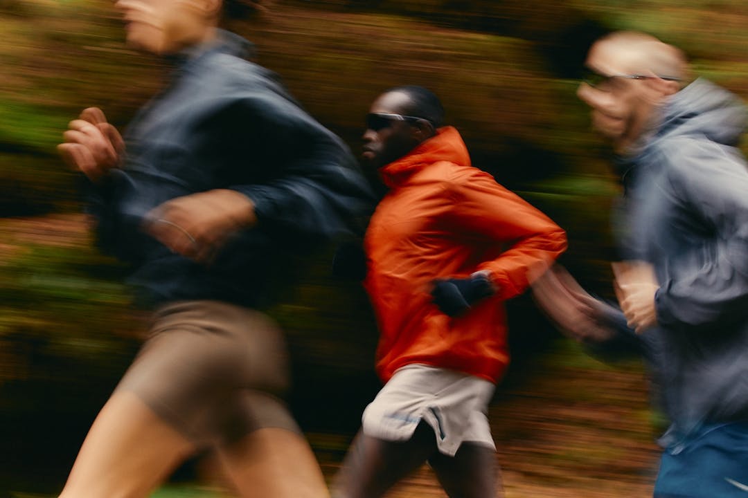 Dynamic motion blur of diverse athletes running outdoors in sports training program
