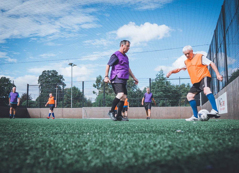 Elderly men playing walking football
