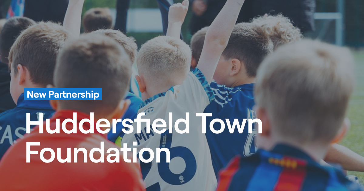 Youth football players in Huddersfield Town kits during community programme - Abler partnership announcement