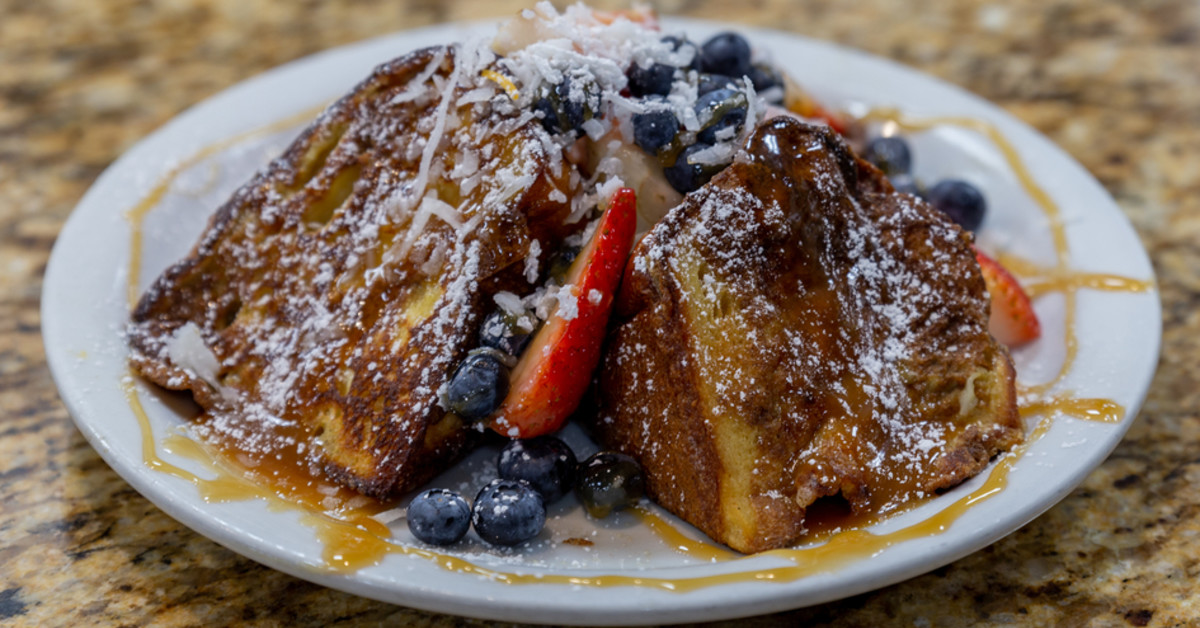 French toast piled high with fruit, syrup, butter and powder sugar! YUM!