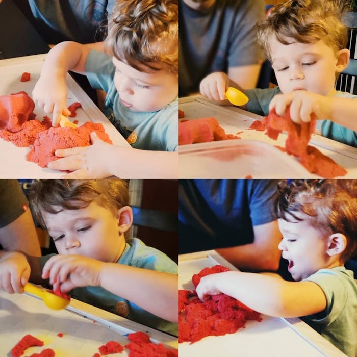 Danielle's son, Luke, playing intently and happily with kinetic sand.