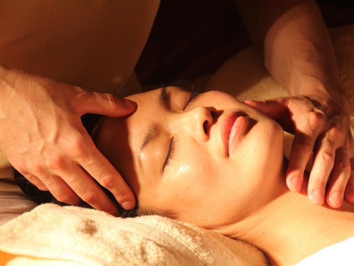 Woman looking relaxed getting face massage