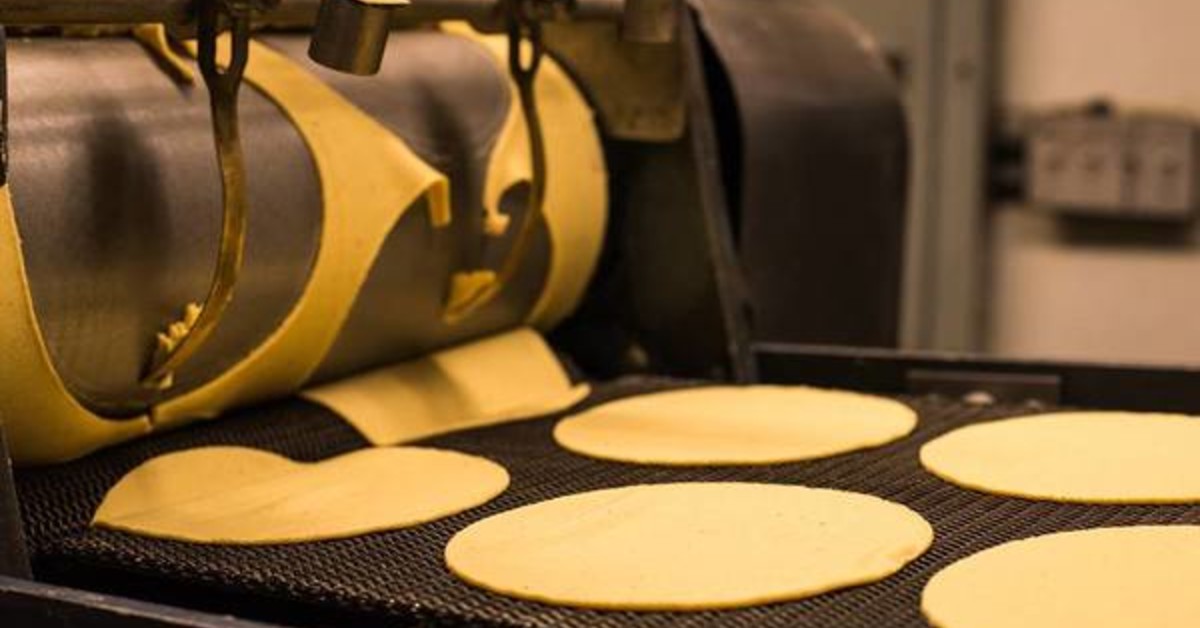 Tortilla machine cutting tortillas into circles