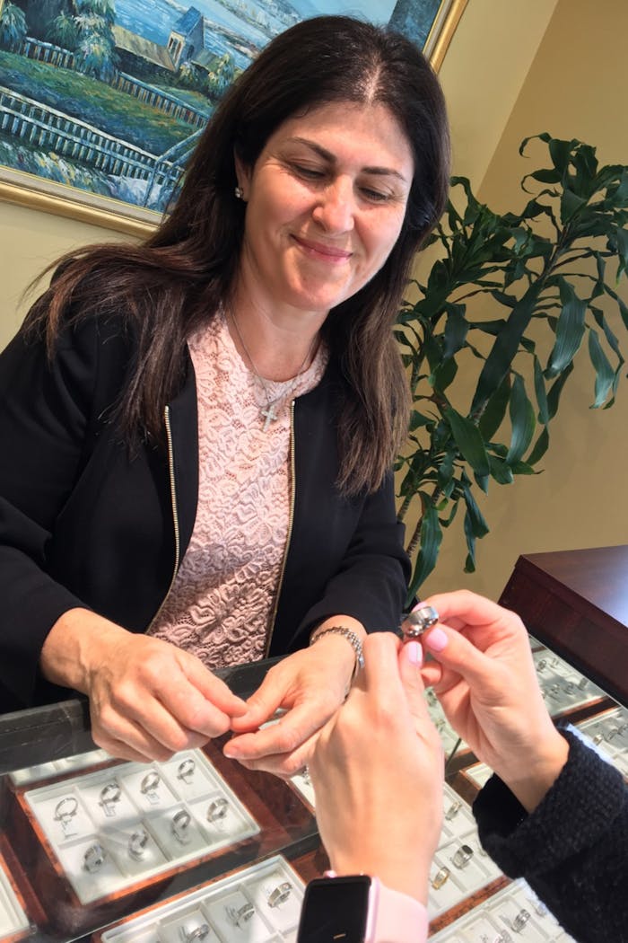 Jeweler watching as customer looks at ring