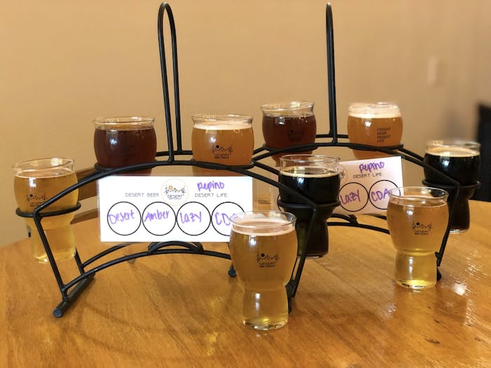 two beer flights sitting one in front of the other. Beers are in order of what is listed below.