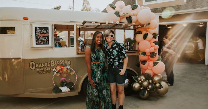 Christina in front of Orange Blossom Bar Cart