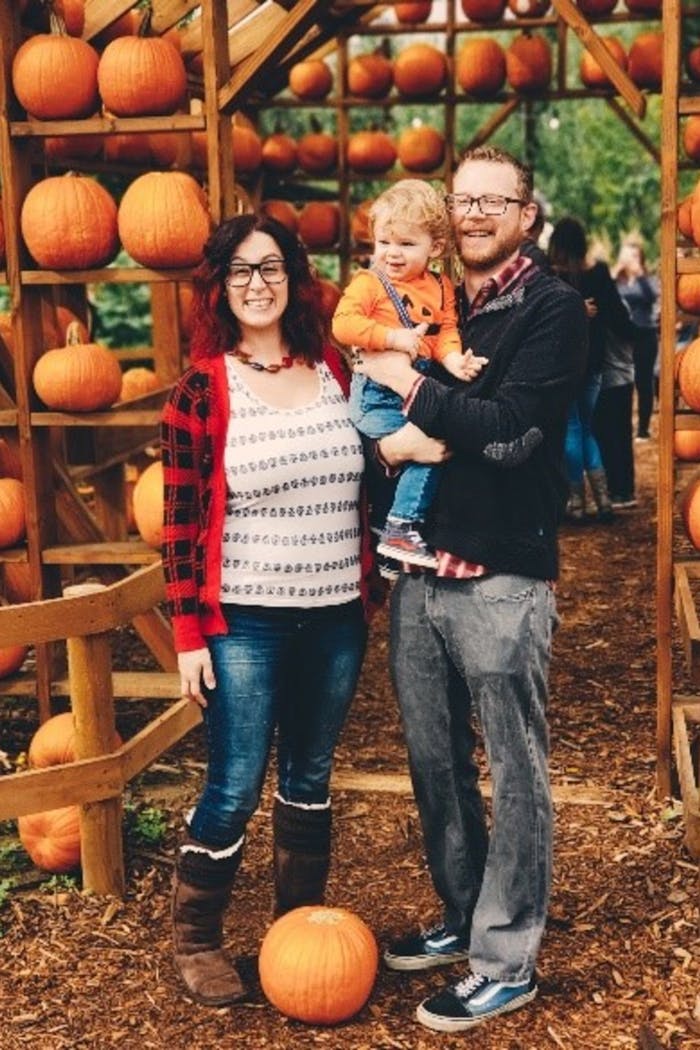 Danielle, her son and husband at the pumpkin patch