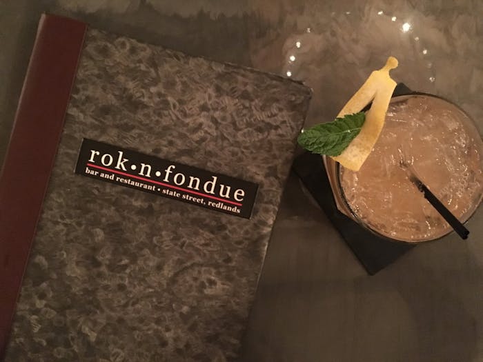 Beautiful cocktail next to Rok n Fondue's menu
