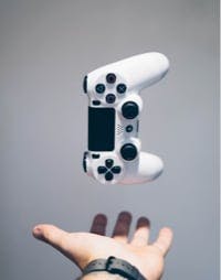 A photo of a man throwing a controller up in the air