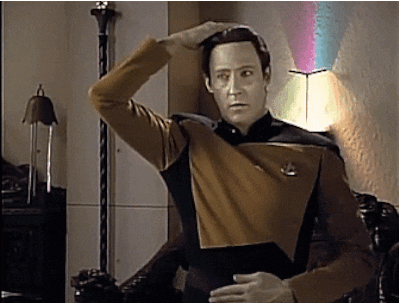 Data rubbing his belly and patting his head