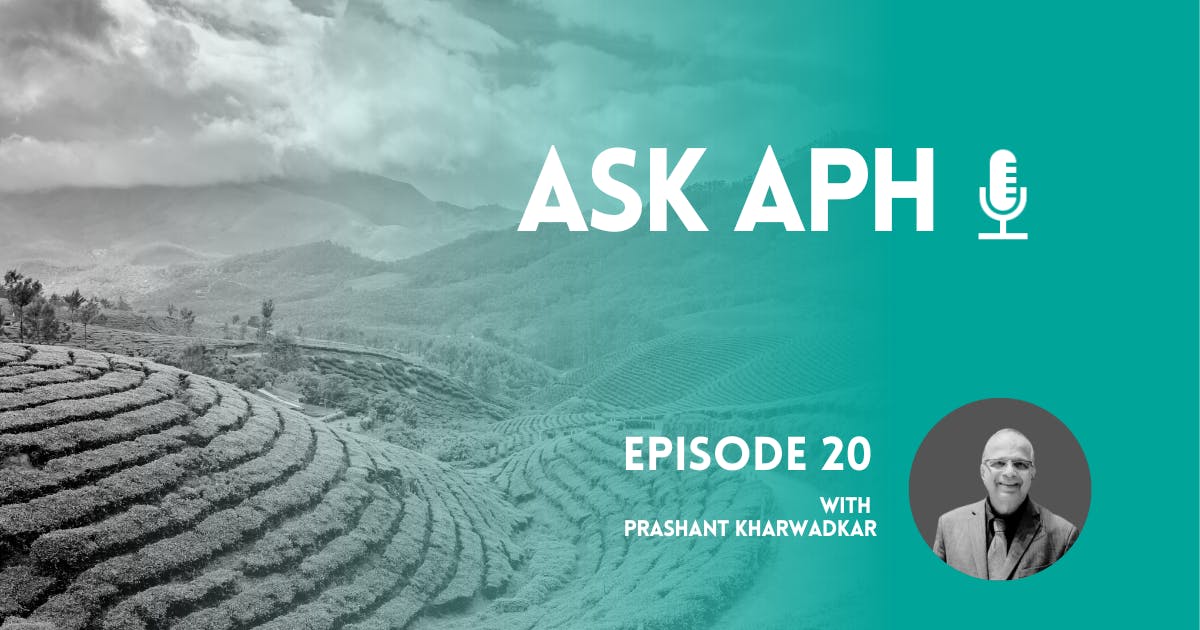 Promotional image for the "Ask APH" podcast, Episode 20, featuring Prashant Kharwadkar. The image shows terraced agricultural fields with misty mountains in the background on the left, and a teal overlay on the right with text that reads "ASK APH," a microphone icon, "Episode 20 with Prashant Kharwadkar," and a circular photo of Prashant Kharwadkar in a suit and glasses.