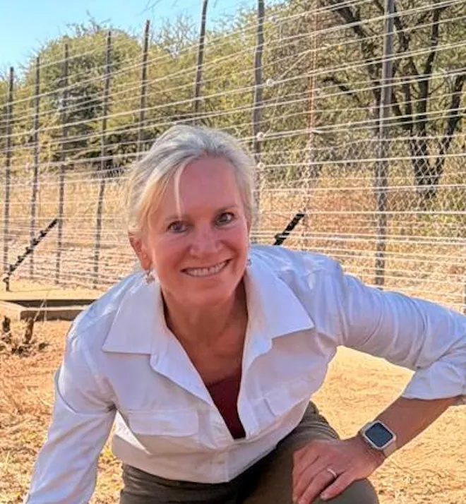 Christine Kay Davis - Volunteer posing with sedated lion
