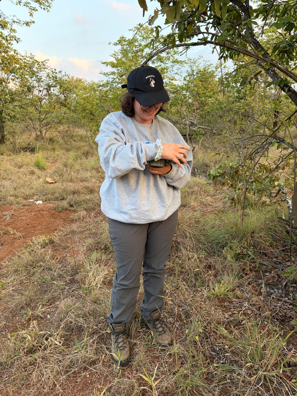 Alegra holding a camera trap