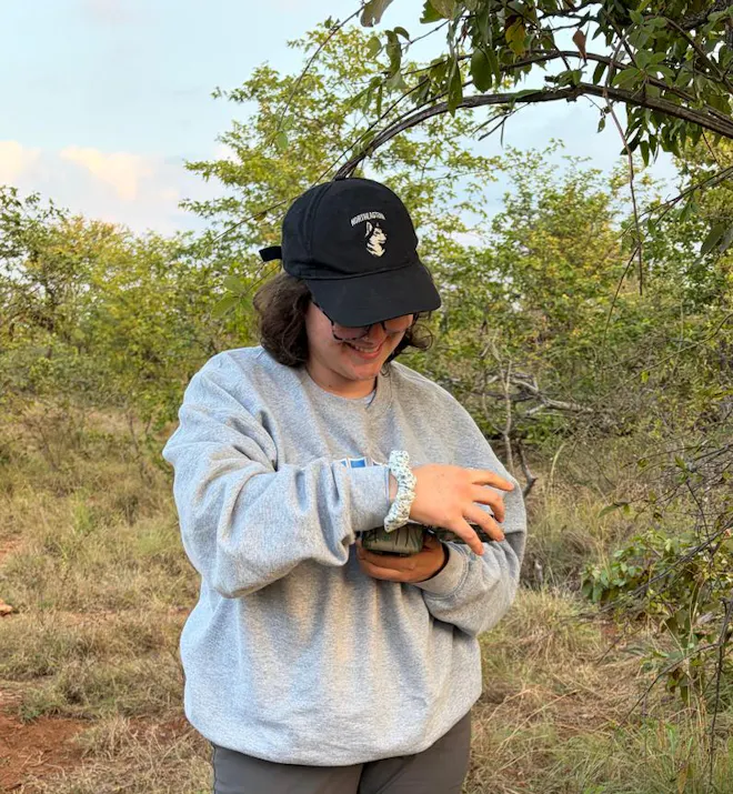 Alegra holding a camera trap
