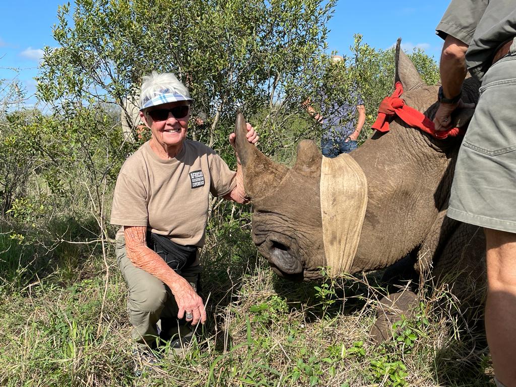 Frances Watson: posing next to a sedated rhino after dehorning