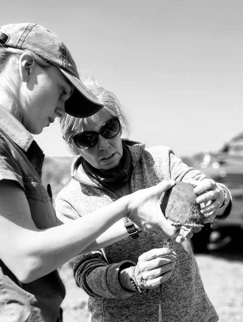 A female ACE volunteer and project staff looking at a rhino horn