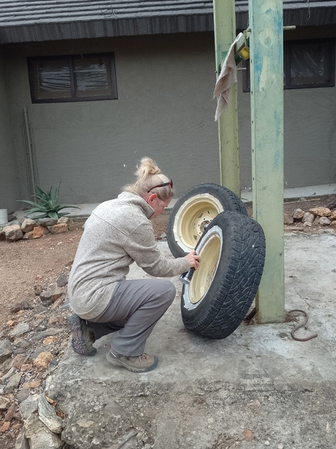 A female ACE volunteer painting tyres