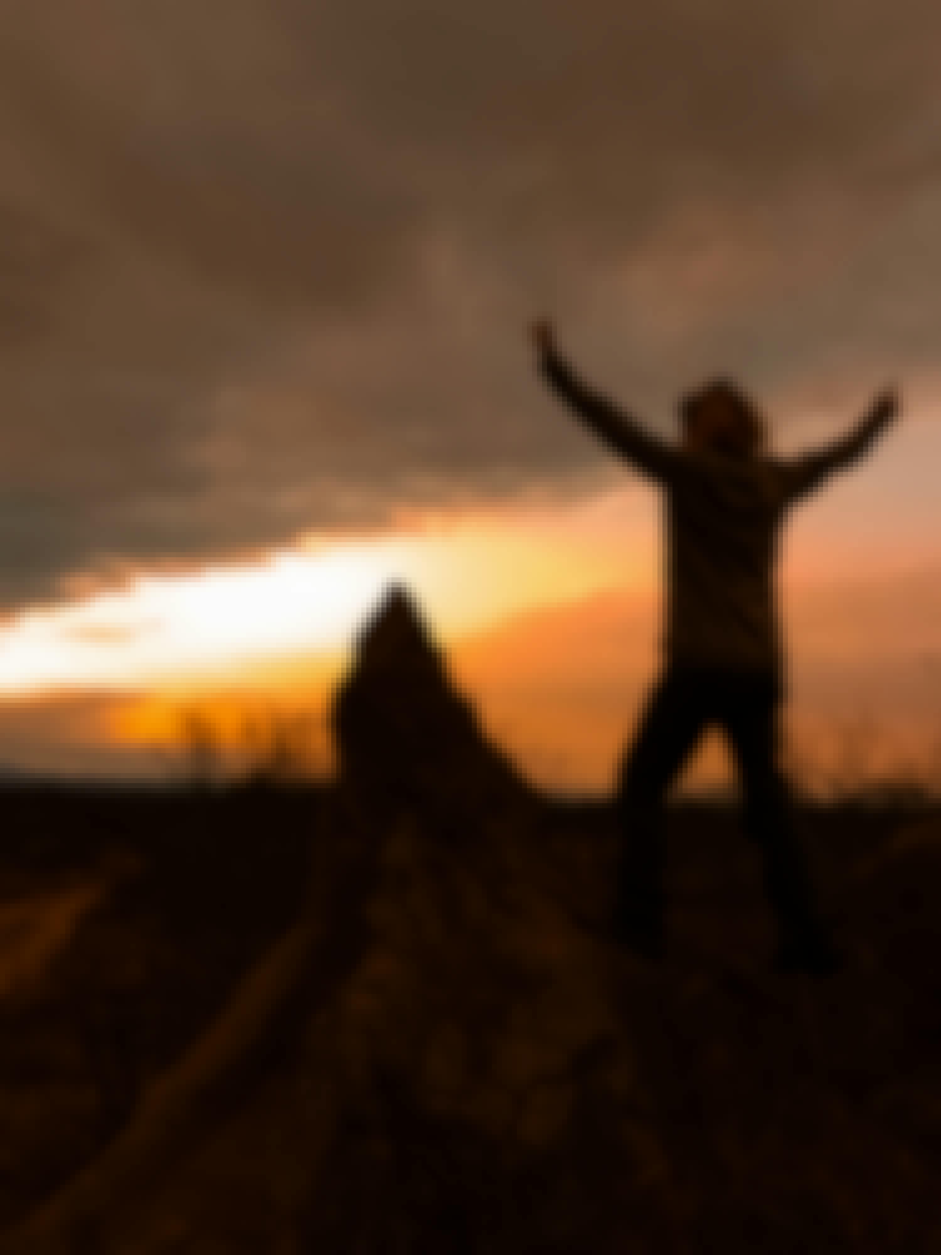 A female posing in front of a sunset