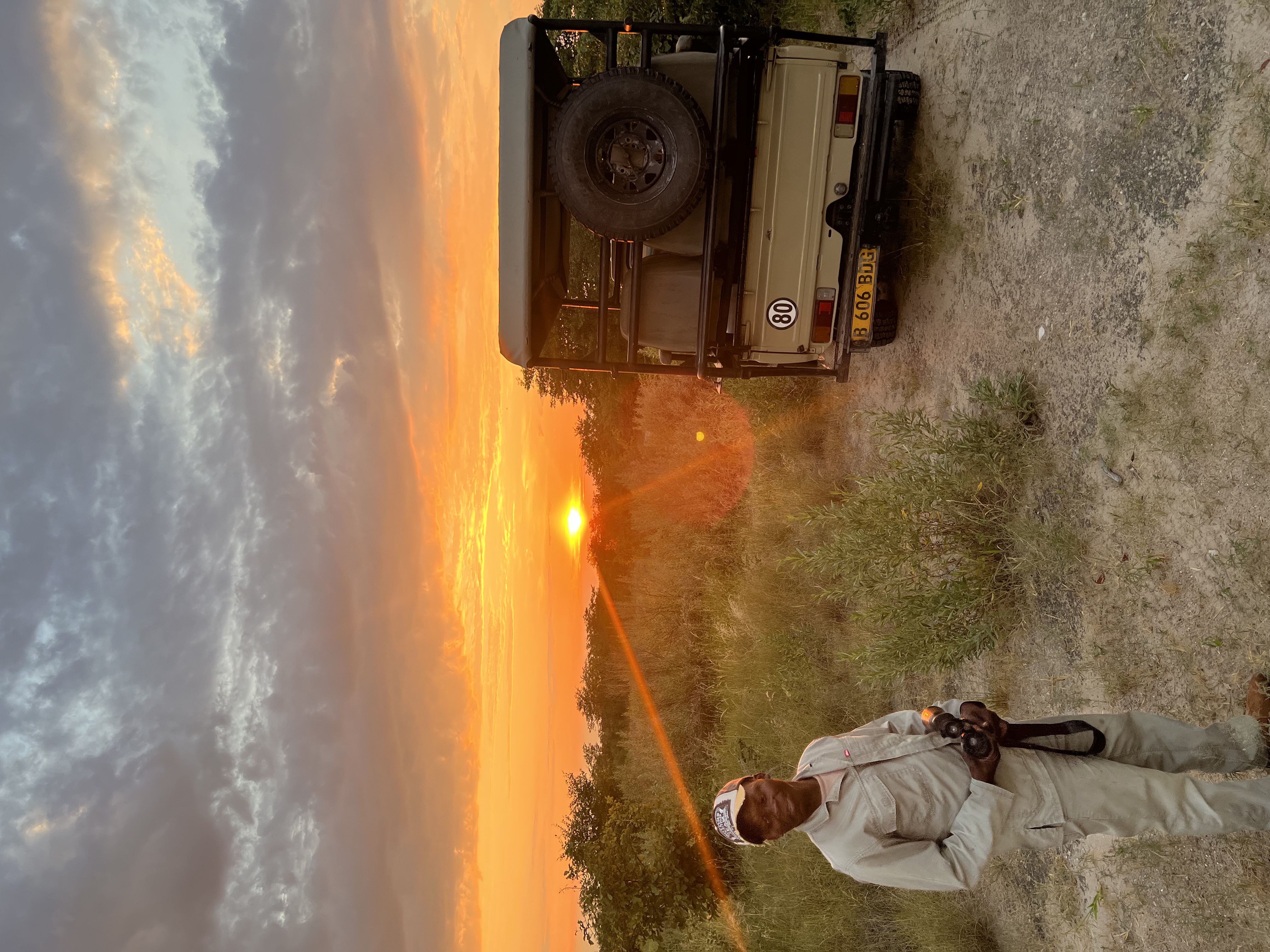 Josie and Adam: A staff member in front of a sunset in the Okavango