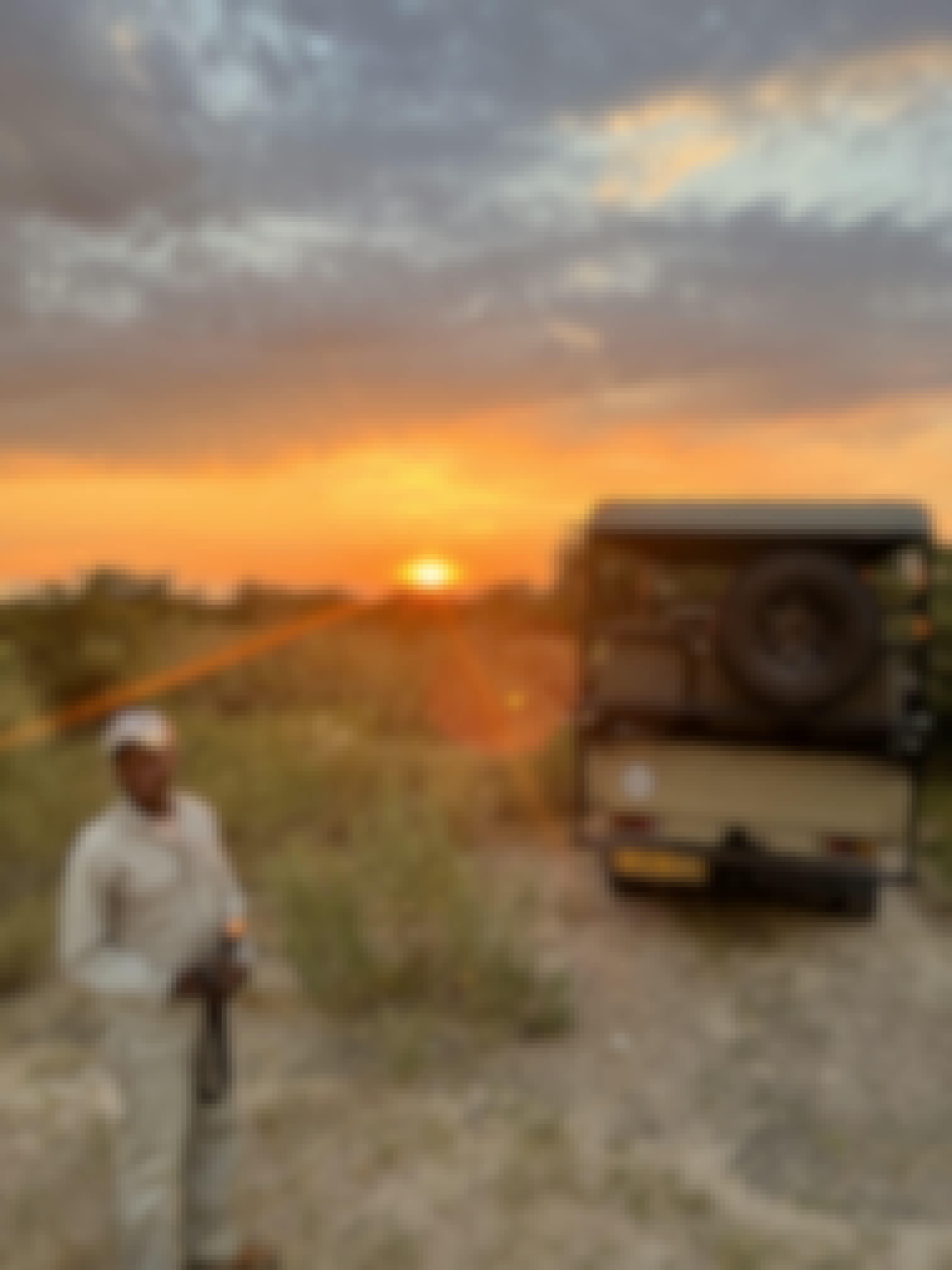 A staff member in front of a sunset in the Okavango