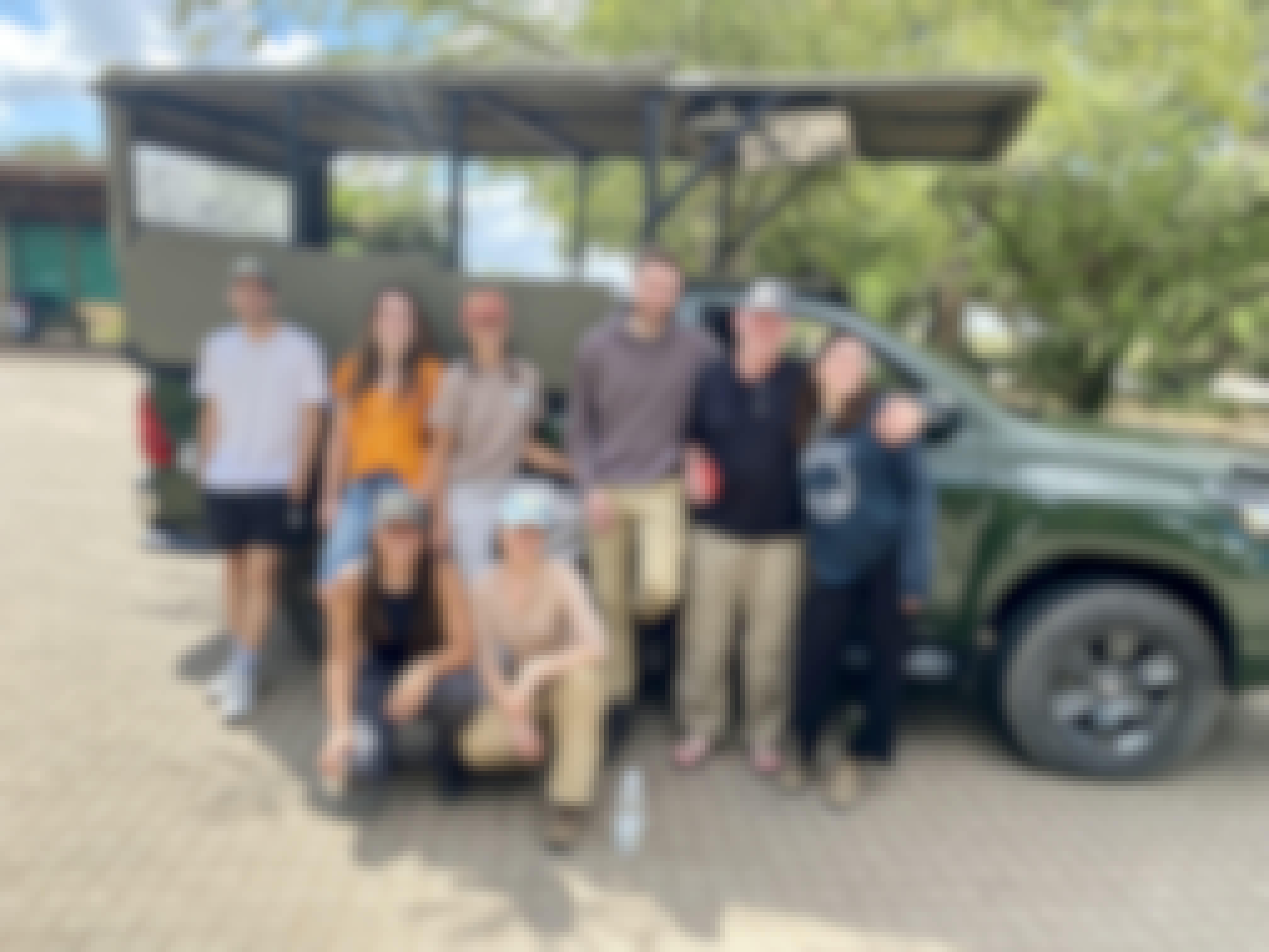 A group pose in front of a vehicle at Moholoholo