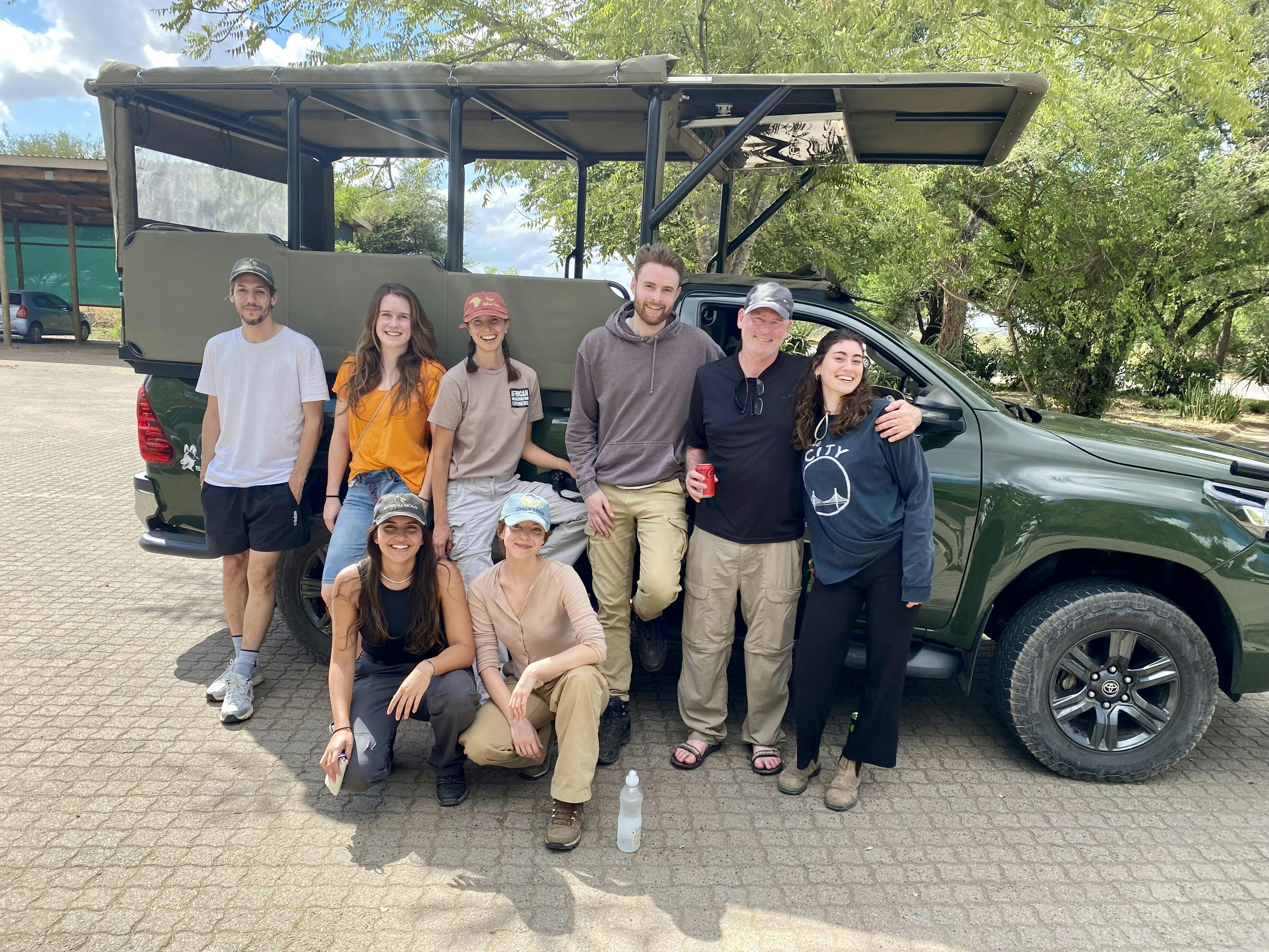 A group pose in front of a vehicle at Moholoholo