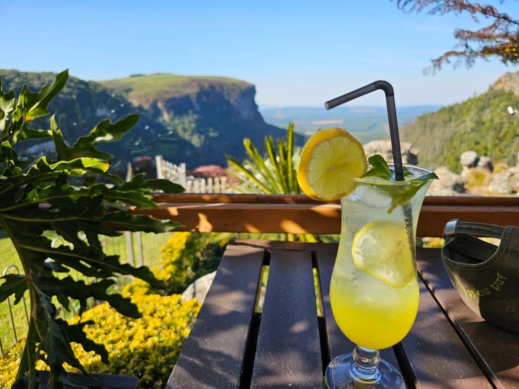 Lauryn Sitton: A drink in front of a beautiful landscape