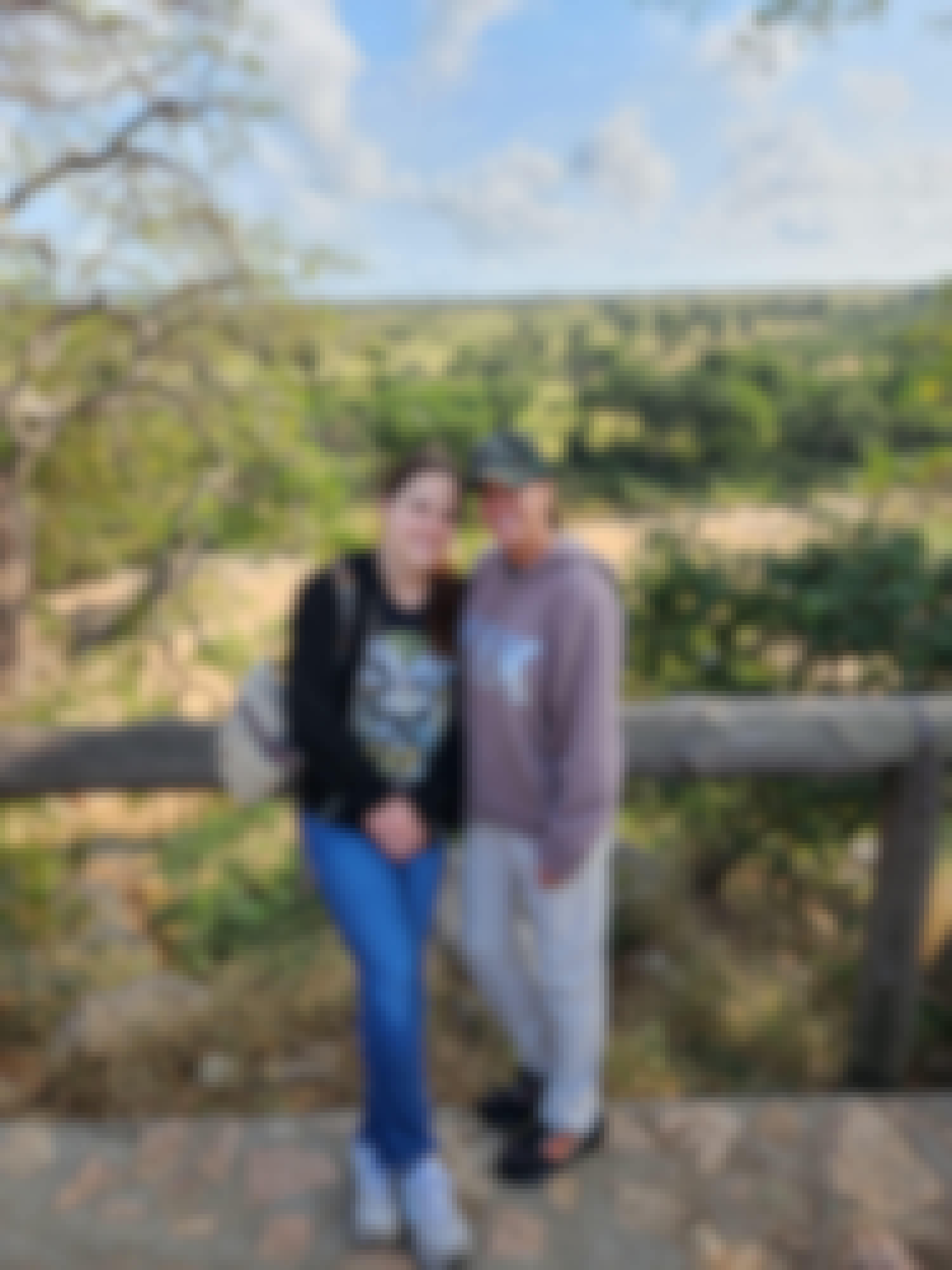 Two women stand in front od a plain