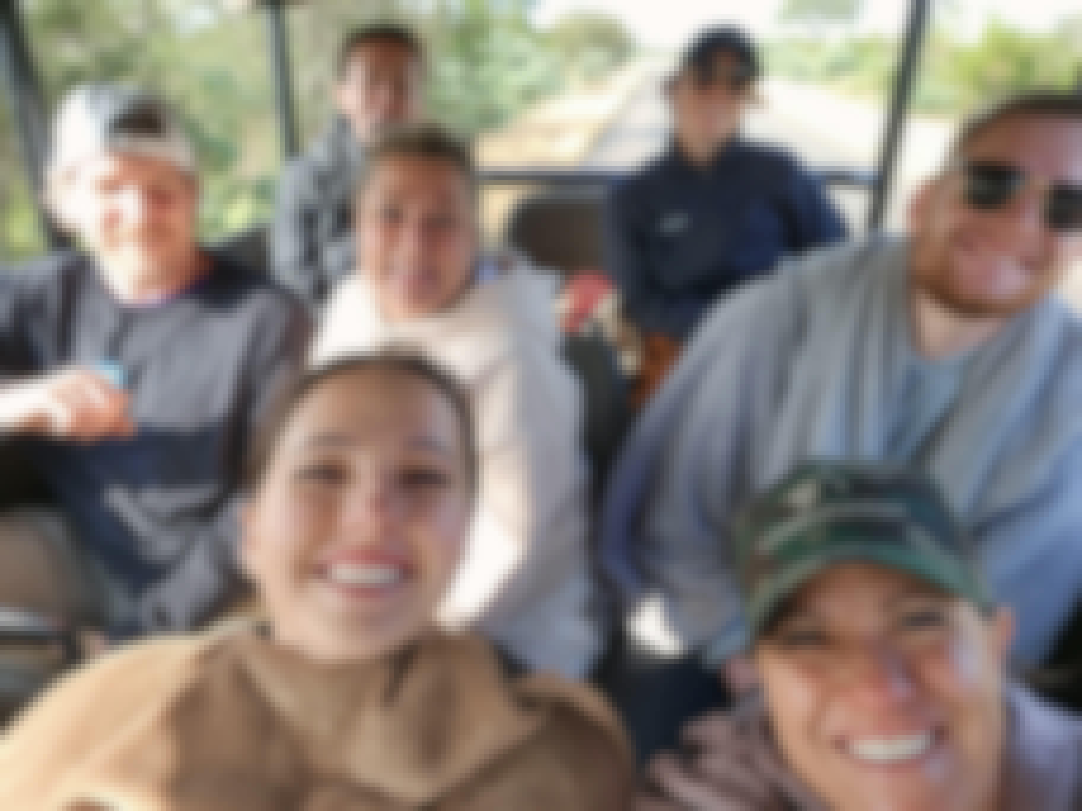 A group of volunteers sat in a vehicle 