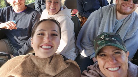 Vanessa and Caydence: A group of volunteers sat in a vehicle
