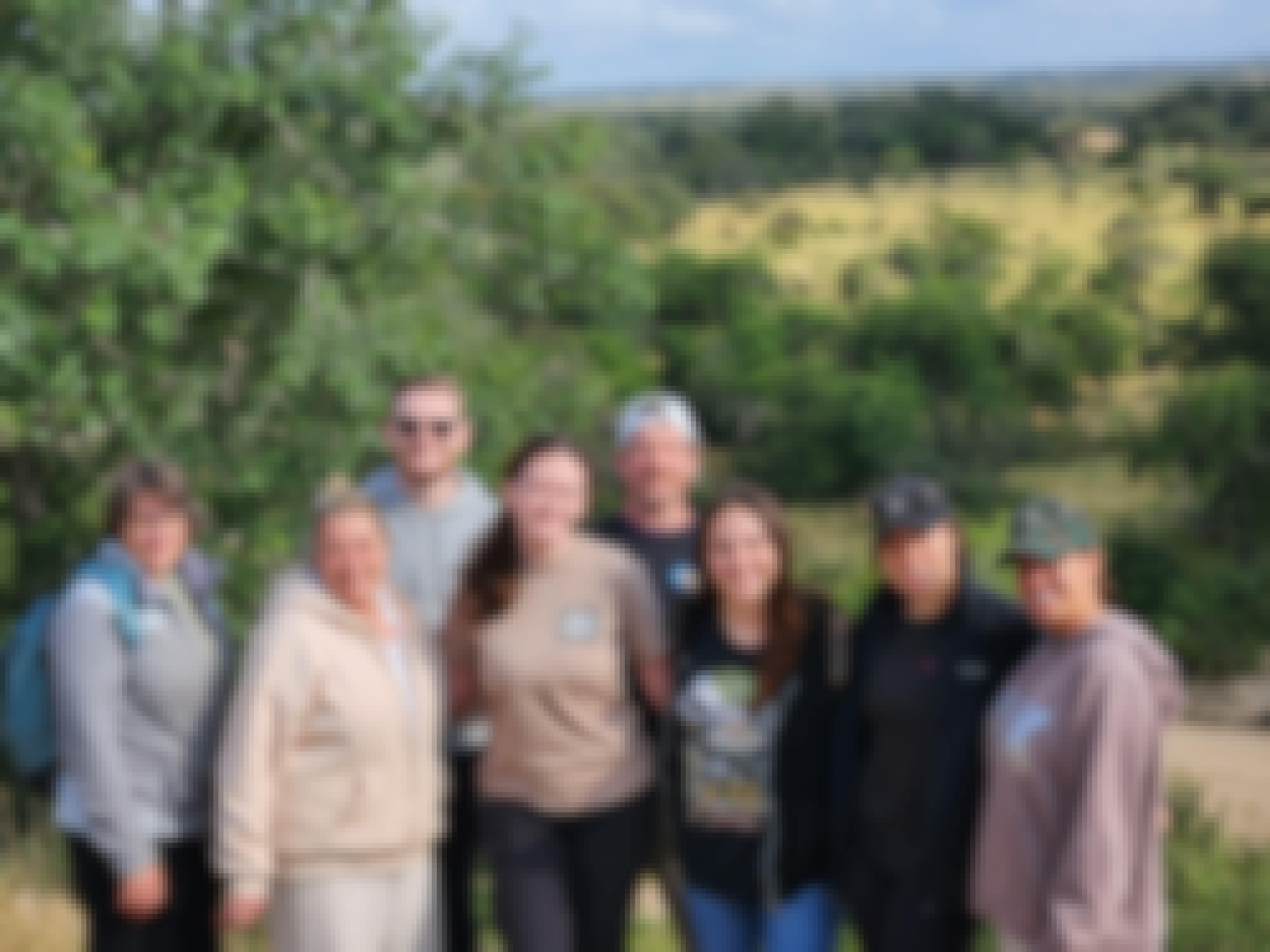 A group of volunteers stood in front of a plain