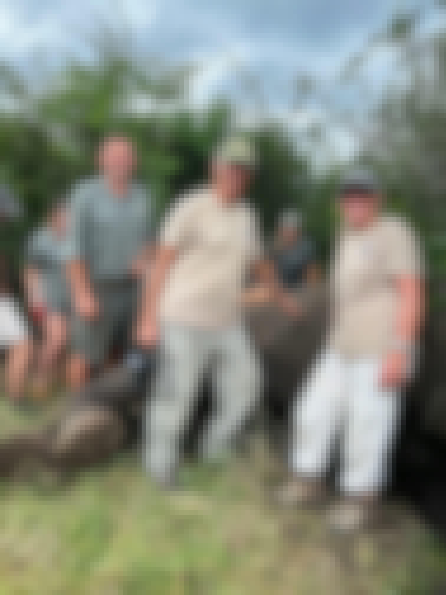 A man and woman stand in front of a sedated elephant