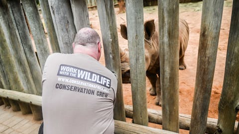 Terence and Victoria Fitzpatrick: bottle feeding a rhino at Care for Wild Africa