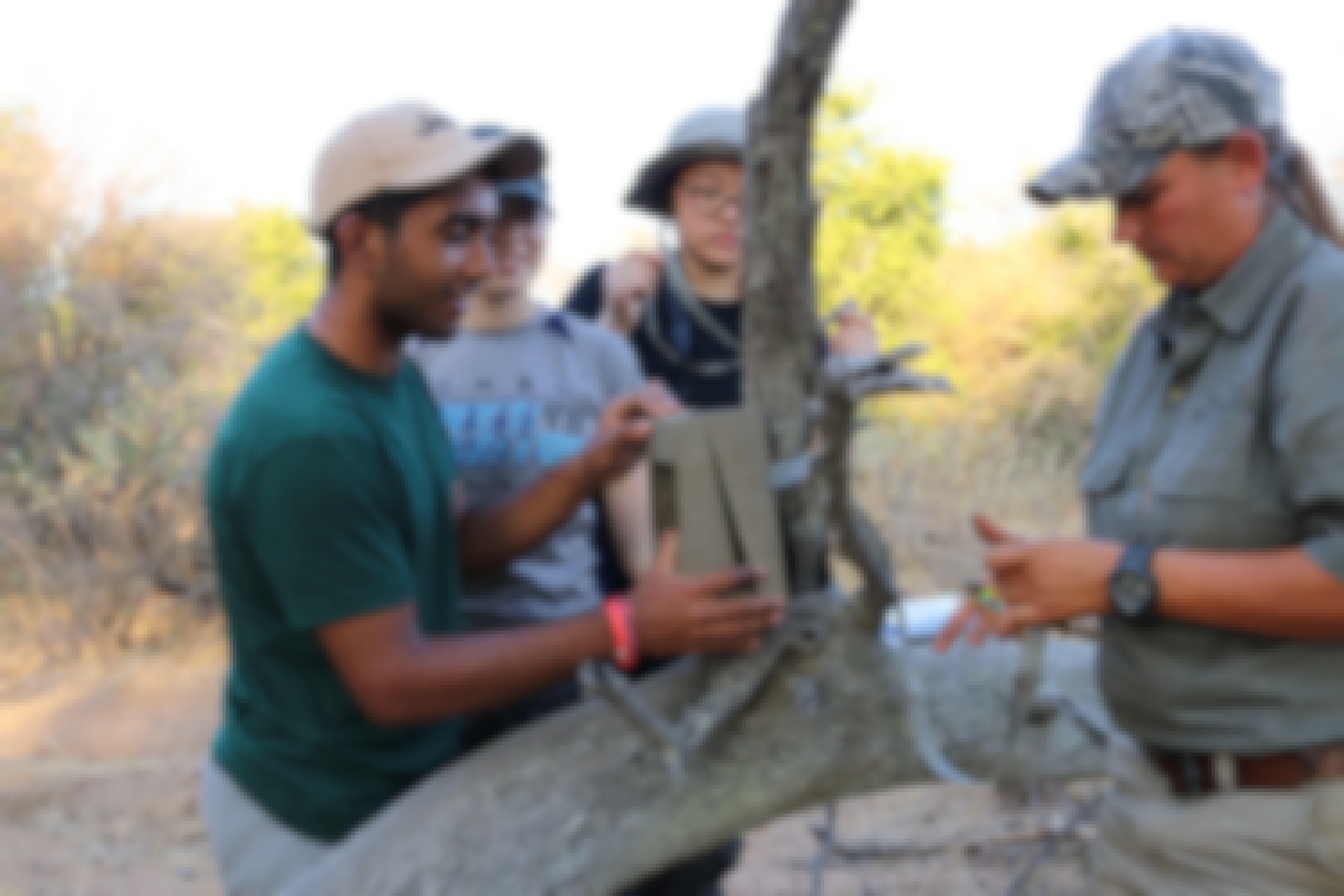 Group of ACE students from a school fitting a camera trap