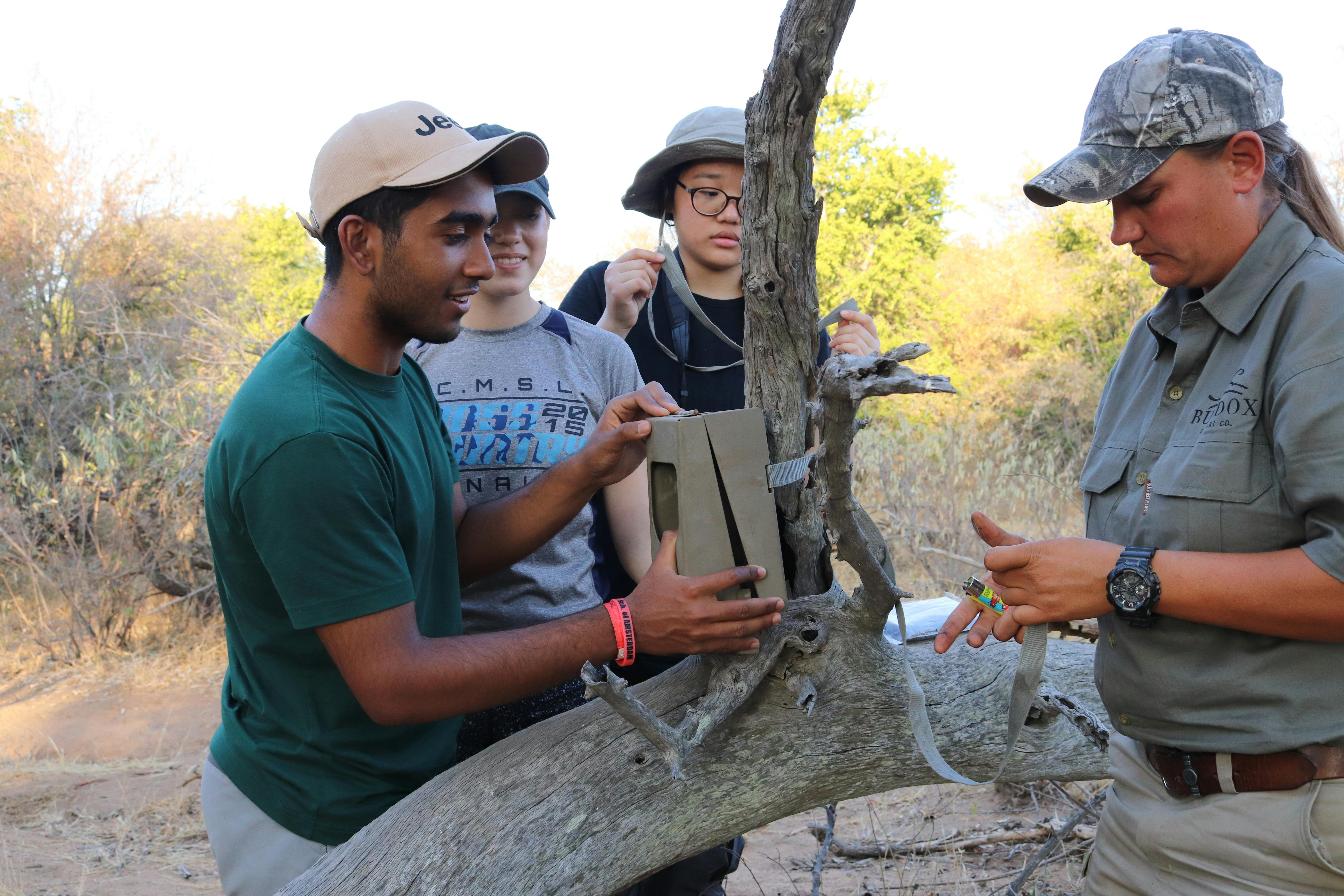 Group of ACE students from a school fitting a camera trap