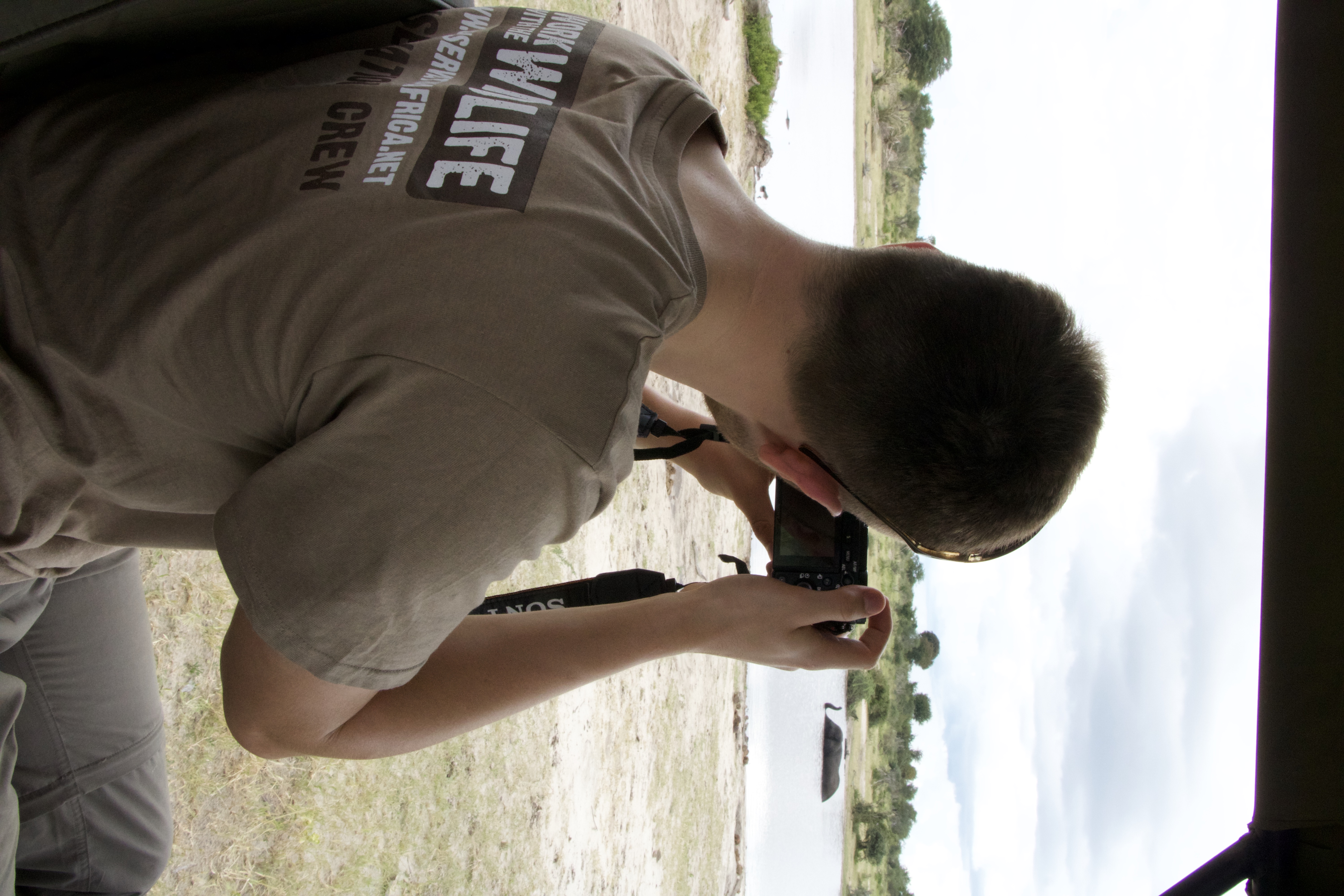 Luke Robinson: A male student takes photos of an elephant in the water
