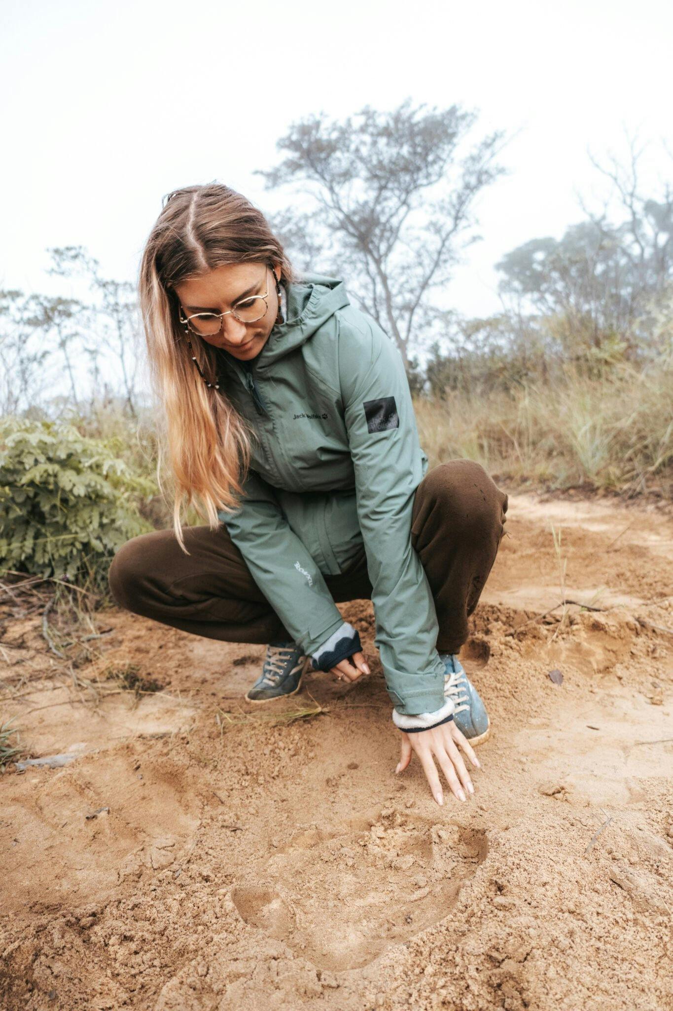 Student looking at rhino tracks