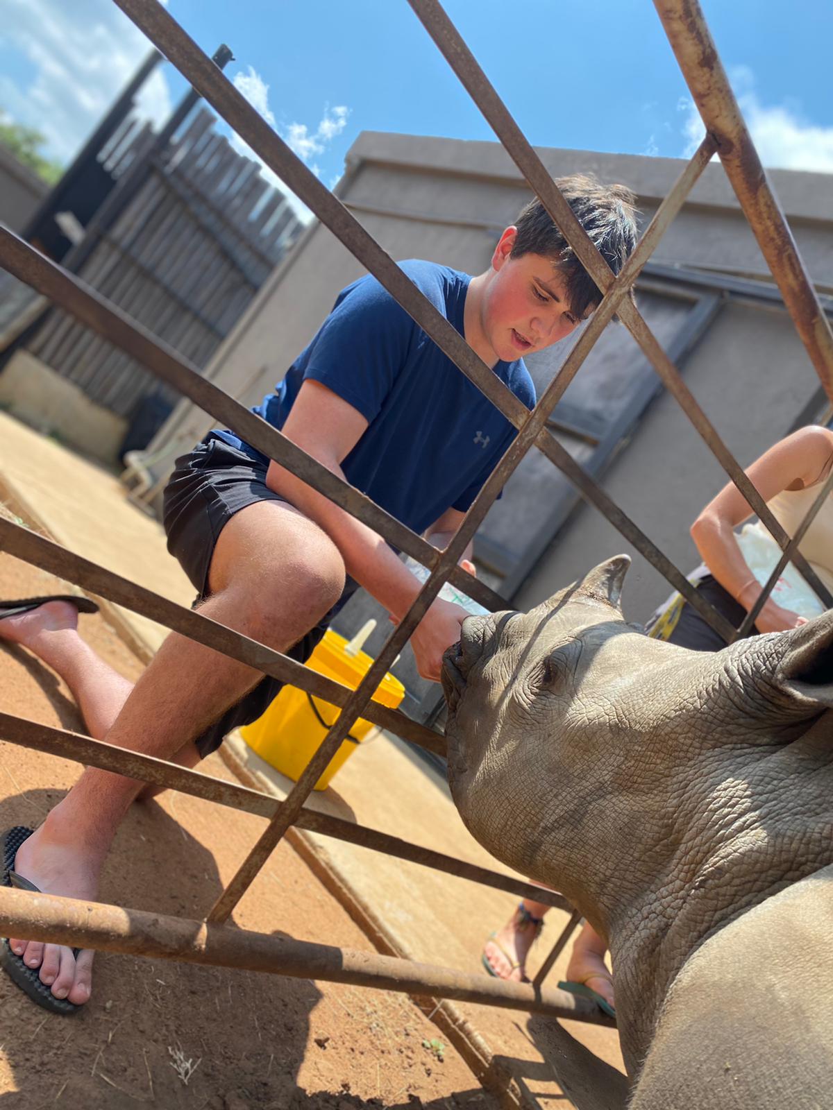 Sam Thain: bottle feeding a rhino