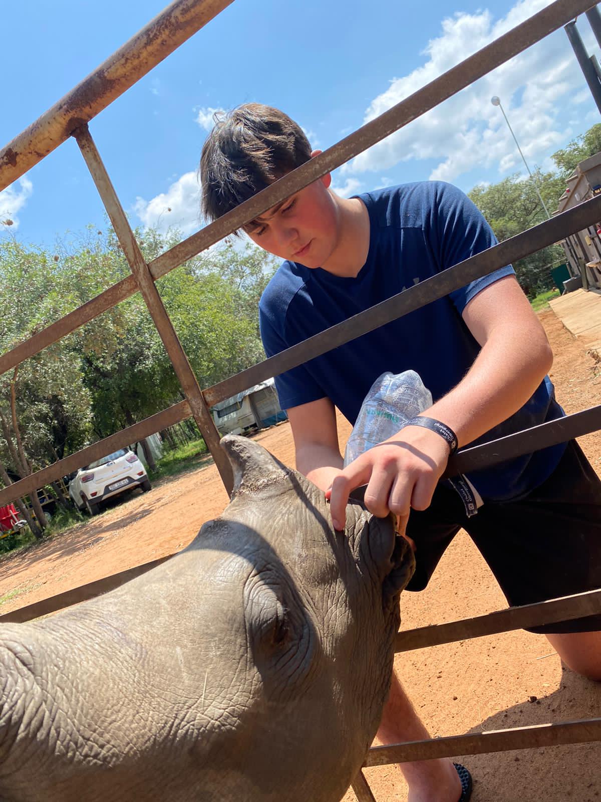Sam Thain: bottle feeding a rhino