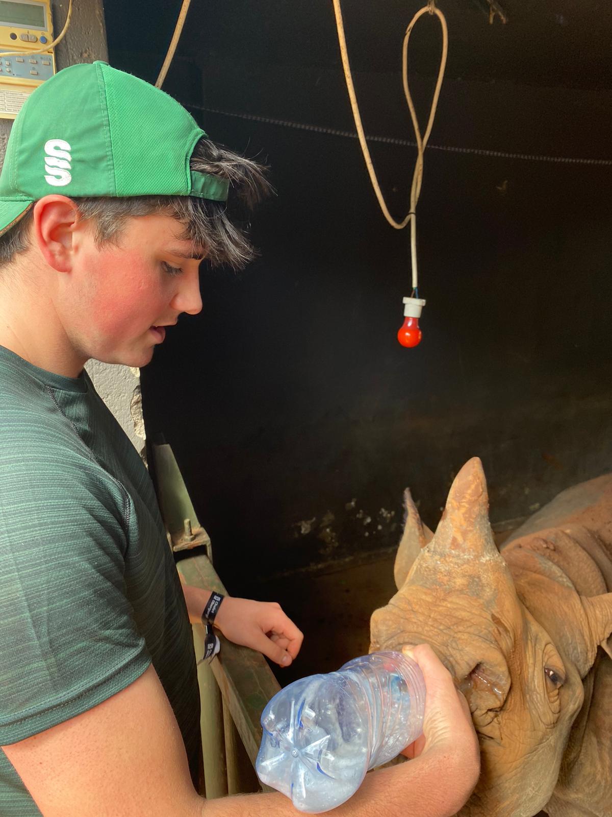 Sam Thain: bottle feeding a rhino