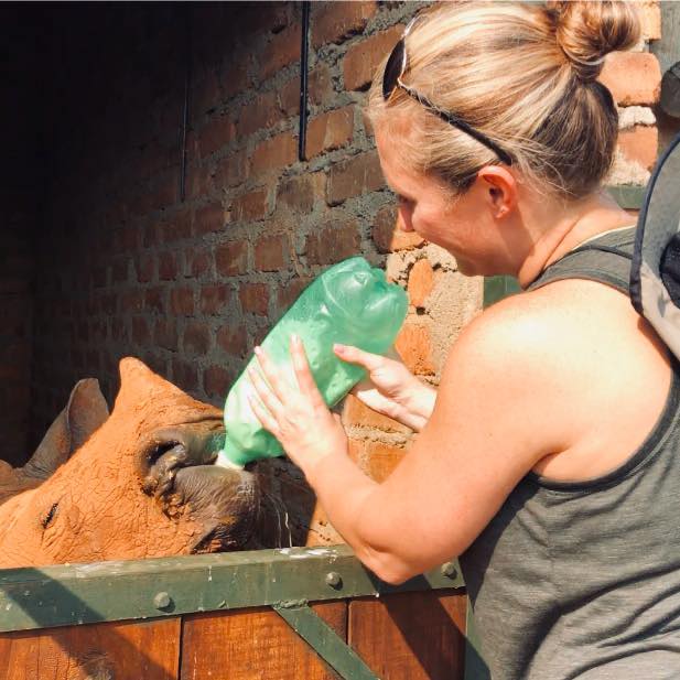 Stephanie Wallace: bottle feeding a rhino